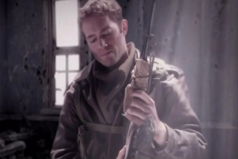 Larry holding a rifle